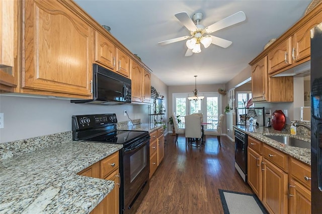 55 Rue De Paix Dr, Lake St Louis, MO 63367 - kitchen featuring black appliances, dark wood-type flooring, light stone countertops, a sink, and brown cabinets