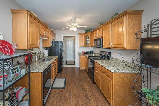 55 Rue De Paix Dr, Lake St Louis, MO 63367 - kitchen with black appliances, a sink, dark wood finished floors, ceiling fan, and light stone counters