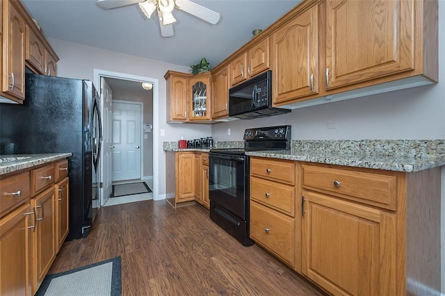 55 Rue De Paix Dr, Lake St Louis, MO 63367 - kitchen featuring black appliances, dark wood-style floors, light stone counters, ceiling fan, and brown cabinetry
