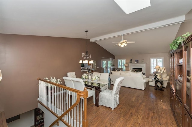 55 Rue De Paix Dr, Lake St Louis, MO 63367 - dining room with dark wood-type flooring, a fireplace, a chandelier, ceiling fan, and a skylight