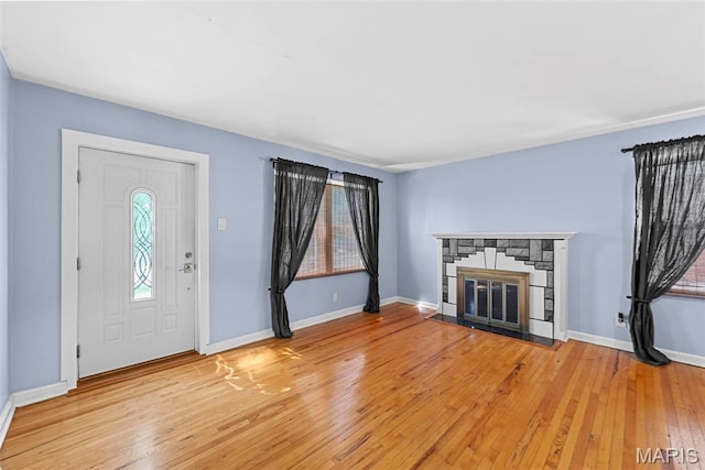 8261 Watson Rd, Saint Louis, MO 63119 - entrance foyer featuring light wood finished floors and a stone fireplace