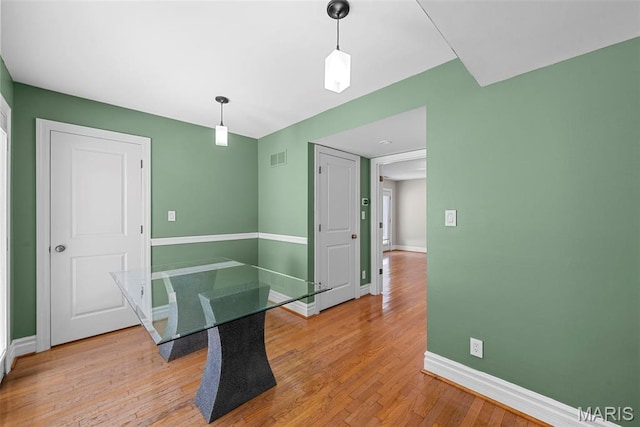8261 Watson Rd, Saint Louis, MO 63119 - unfurnished dining area with baseboards and light wood-style flooring