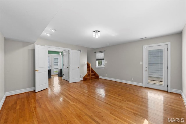 8261 Watson Rd, Saint Louis, MO 63119 - unfurnished living room with light wood-type flooring and stairway