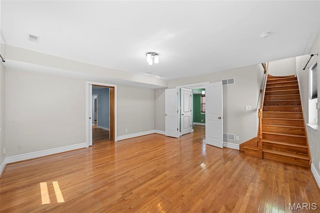 8261 Watson Rd, Saint Louis, MO 63119 - empty room featuring light wood-type flooring, stairs, and a smoke detector