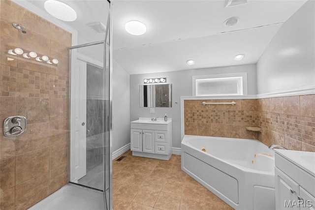 8261 Watson Rd, Saint Louis, MO 63119 - bathroom featuring vanity, a shower stall, a jetted tub, tile patterned floors, and vaulted ceiling