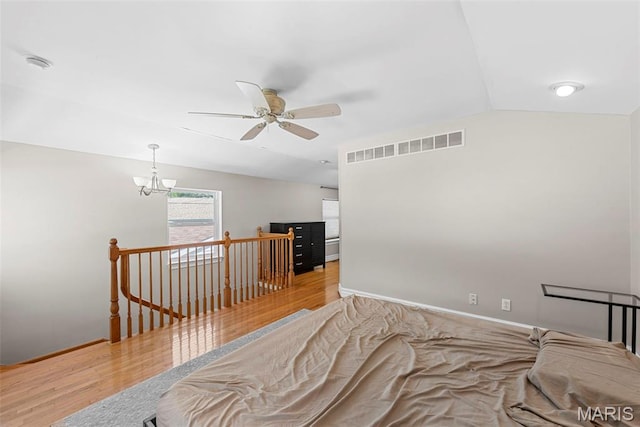 8261 Watson Rd, Saint Louis, MO 63119 - bedroom featuring wood finished floors, lofted ceiling, a chandelier, and ceiling fan