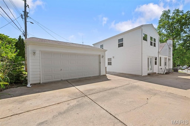 8261 Watson Rd, Saint Louis, MO 63119 - view of side of home featuring a detached garage, an outbuilding, and entry steps