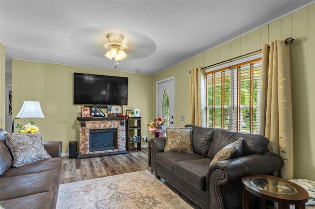 24864 Bcr 326, Marble Hill, MO 63764 - living area with wood finished floors, ceiling fan, and a stone fireplace