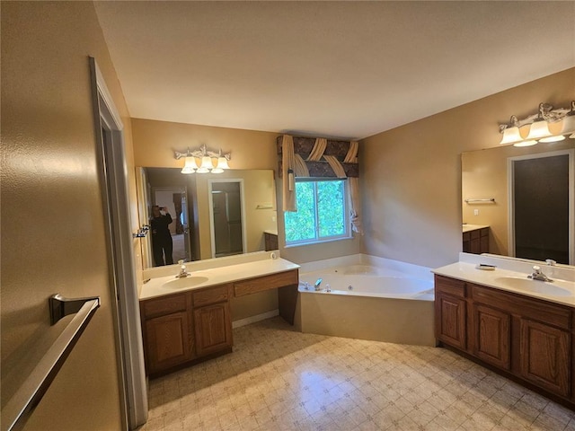 826 Oak Mill Ln, Imperial, MO 63052 - bathroom featuring two vanities, a garden tub, and tile patterned floors