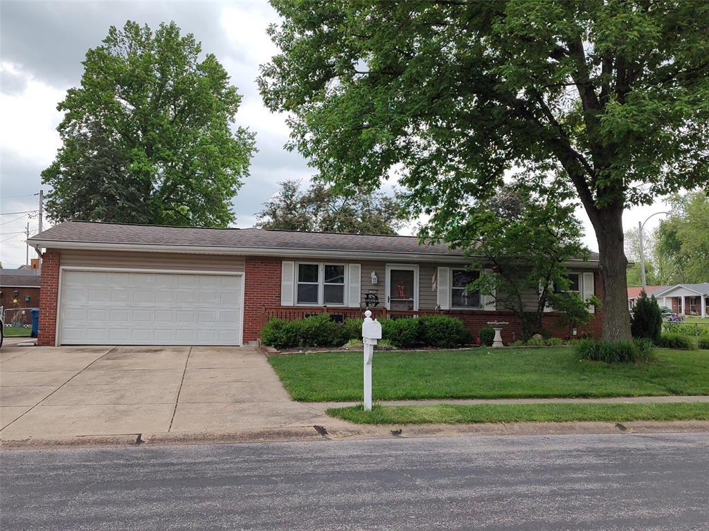 ranch-style house with concrete driveway, brick siding, an attached garage, and a front lawn