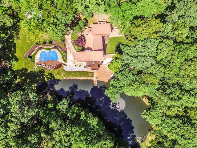 view of subject property with a pool and a nearby body of water