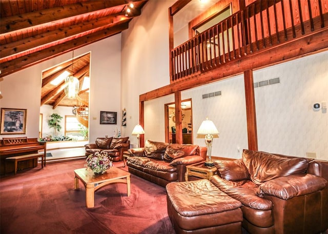 carpeted living room featuring beamed ceiling, high vaulted ceiling, and wood ceiling