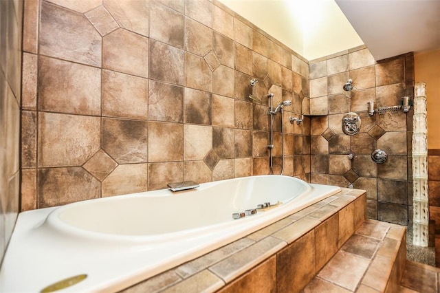 bathroom with tiled shower, tiled bath, and tile walls
