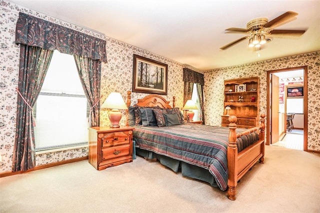 bedroom featuring wallpapered walls, carpet, a ceiling fan, and baseboards