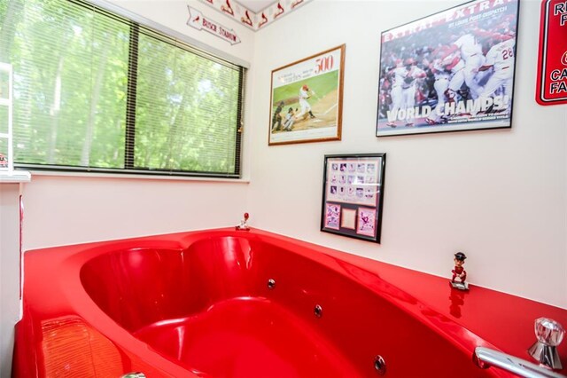 full bathroom with healthy amount of natural light and a jetted tub