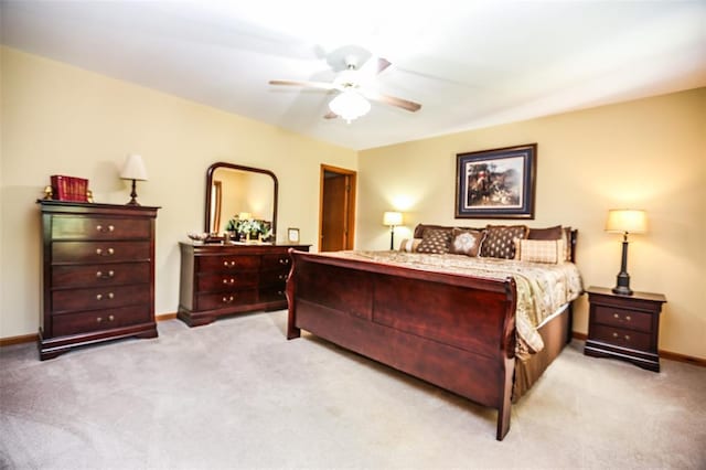 bedroom featuring light carpet, baseboards, and ceiling fan