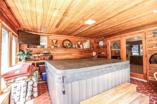 bar featuring wood ceiling, healthy amount of natural light, and wood walls