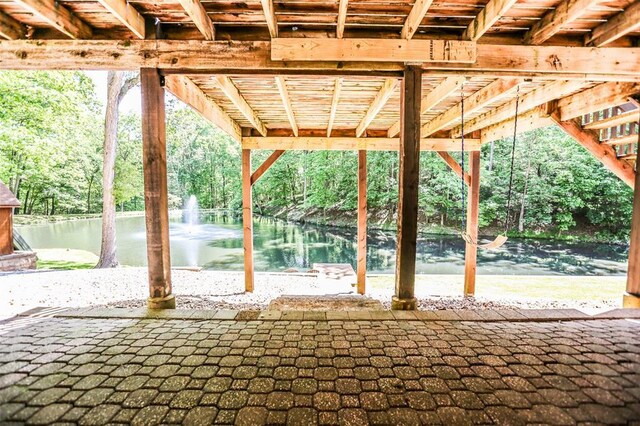 view of patio with a water view