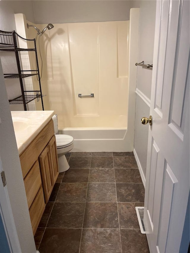 full bath featuring toilet, baseboards, vanity, and shower / bathtub combination