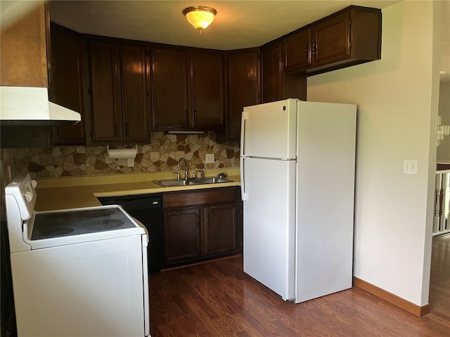 kitchen with white appliances, a sink, dark wood-type flooring, and dark brown cabinetry