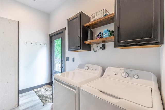 1300 River Valley Rd, Doniphan, MO 63935 - laundry area with washing machine and clothes dryer, cabinet space, and light wood finished floors