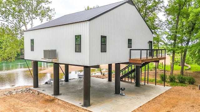 1300 River Valley Rd, Doniphan, MO 63935 - rear view of house with a carport, a patio area, stairway, central AC, and a deck with water view