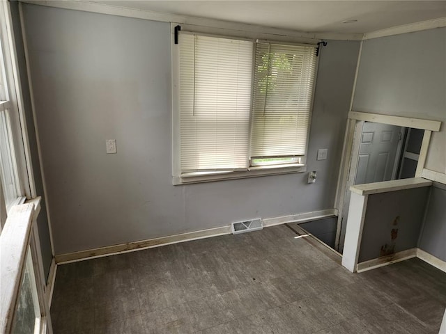 129 N Pence St, East Alton, IL 62024 - unfurnished room featuring dark flooring, ornamental molding, and baseboards