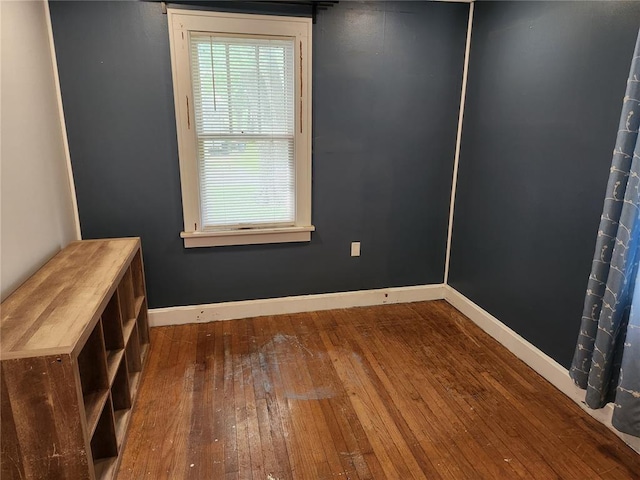 129 N Pence St, East Alton, IL 62024 - spare room with wood-type flooring, plenty of natural light, and baseboards