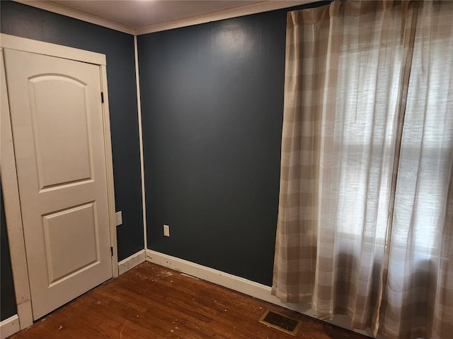 129 N Pence St, East Alton, IL 62024 - spare room featuring dark wood-style floors and baseboards