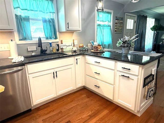 106 W Iowa St, Trenton, IL 62293 - kitchen featuring stainless steel dishwasher, a sink, a peninsula, and wood finished floors