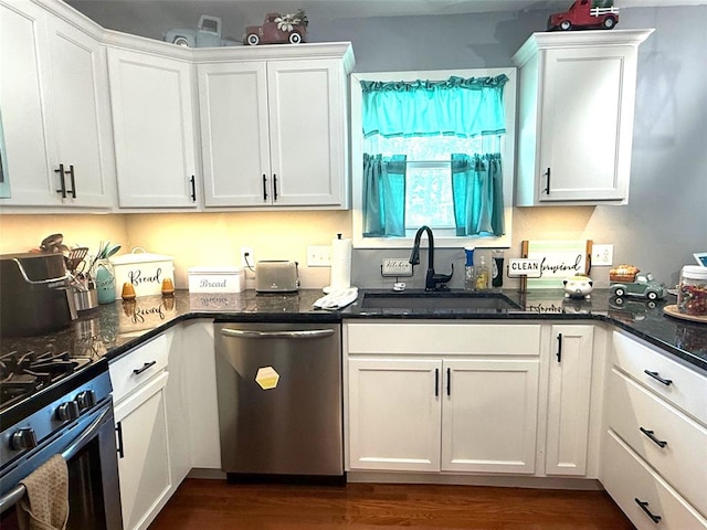 106 W Iowa St, Trenton, IL 62293 - kitchen with appliances with stainless steel finishes, a sink, white cabinetry, dark wood-style floors, and dark stone counters