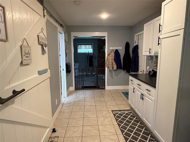 106 W Iowa St, Trenton, IL 62293 - mudroom with light tile patterned floors, baseboards, and a barn door