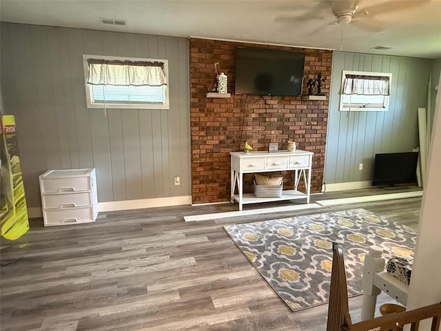106 W Iowa St, Trenton, IL 62293 - living area featuring baseboards, plenty of natural light, wood finished floors, a ceiling fan, and wooden walls
