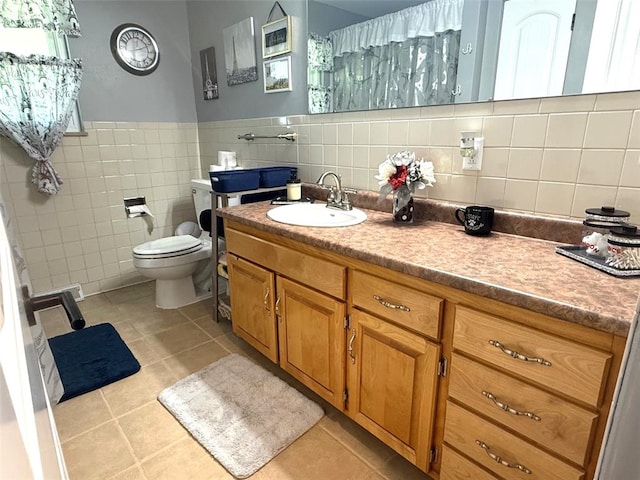 106 W Iowa St, Trenton, IL 62293 - bathroom featuring tile patterned flooring, vanity, toilet, tile walls, and wainscoting