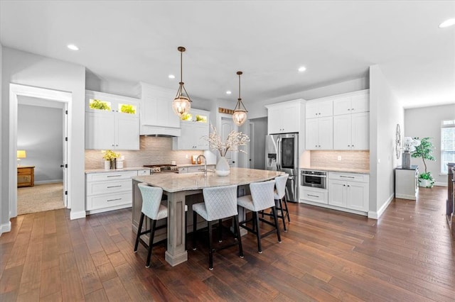 2604 Center Ave, Wildwood, MO 63040 - kitchen featuring stainless steel appliances, a sink, tasteful backsplash, recessed lighting, and white cabinetry