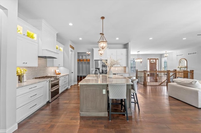2604 Center Ave, Wildwood, MO 63040 - kitchen with appliances with stainless steel finishes, recessed lighting, backsplash, a chandelier, and white cabinets