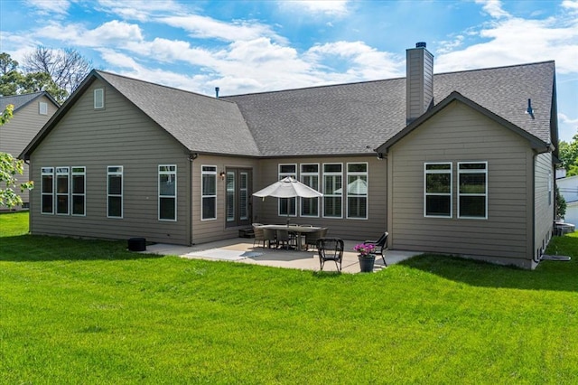 2604 Center Ave, Wildwood, MO 63040 - back of property with a yard, a patio area, a chimney, and a shingled roof