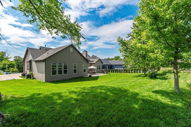 2604 Center Ave, Wildwood, MO 63040 - rear view of house with a yard, central AC, and a patio