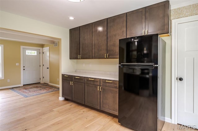 10 Jade Ln, Washington, MO 63090 - kitchen featuring freestanding refrigerator, light wood-style flooring, dark brown cabinets, light countertops, and recessed lighting