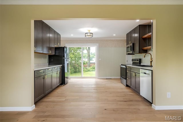 10 Jade Ln, Washington, MO 63090 - kitchen with stainless steel appliances, crown molding, light wood-style floors, open shelves, and light countertops