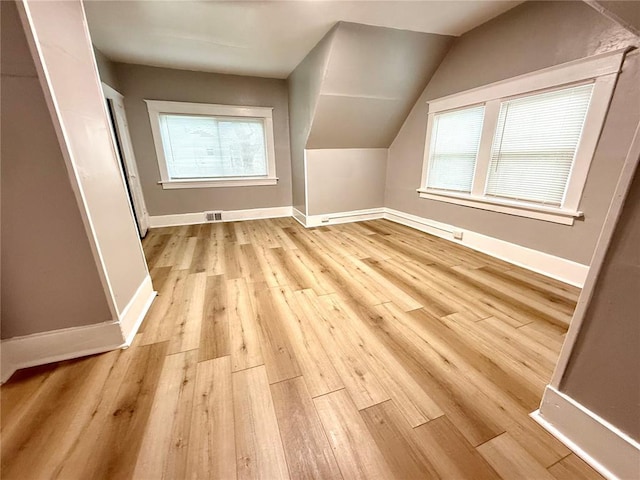 2327 Shirley Ave, Jennings, MO 63136 - bonus room with light wood-style floors, baseboards, and lofted ceiling