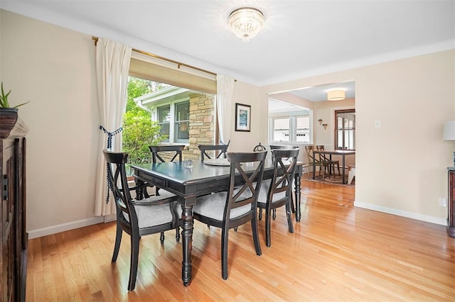 5 Homestead Acres, Olivette, MO 63132 - dining area with light wood finished floors, healthy amount of natural light, baseboards, and a chandelier