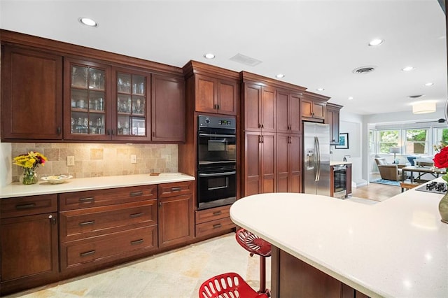 5 Homestead Acres, Olivette, MO 63132 - kitchen featuring stainless steel refrigerator with ice dispenser, recessed lighting, light countertops, glass insert cabinets, and decorative backsplash