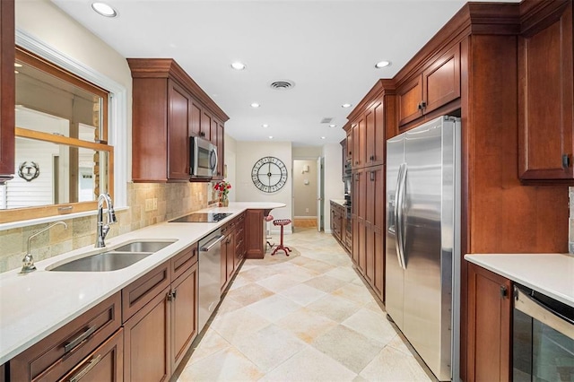5 Homestead Acres, Olivette, MO 63132 - kitchen with appliances with stainless steel finishes, a sink, recessed lighting, light countertops, and backsplash