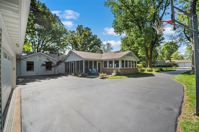 5 Homestead Acres, Olivette, MO 63132 - ranch-style house featuring a sunroom, asphalt driveway, and a chimney