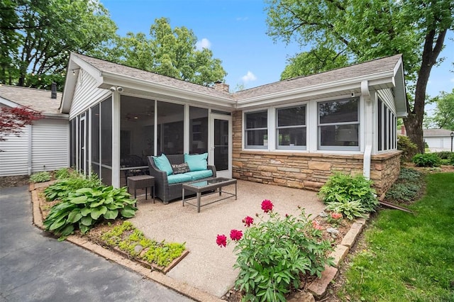 5 Homestead Acres, Olivette, MO 63132 - rear view of house featuring a sunroom, stone siding, and a shingled roof