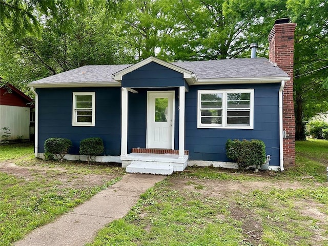 317 Marion Ave, Sikeston, MO 63801 - view of front of home with a chimney and a shingled roof