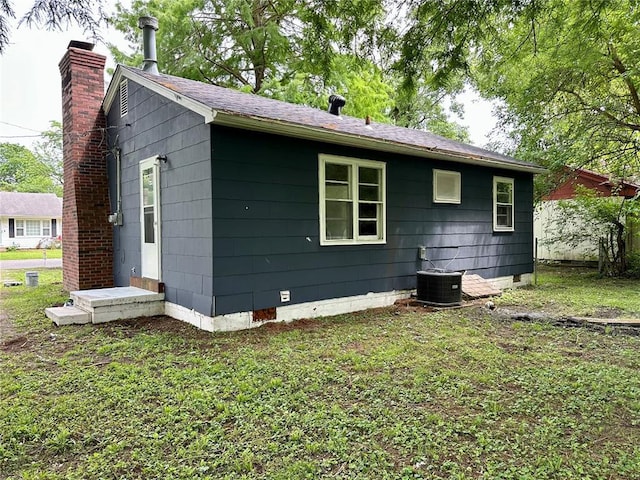317 Marion Ave, Sikeston, MO 63801 - back of house with crawl space, a lawn, and a chimney