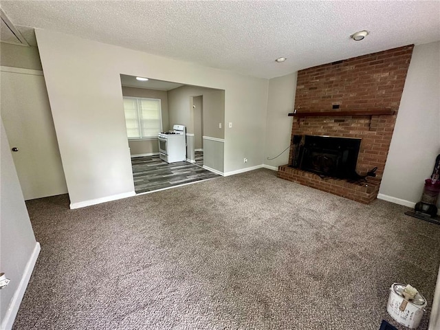317 Marion Ave, Sikeston, MO 63801 - unfurnished living room with dark colored carpet, a textured ceiling, baseboards, and a fireplace