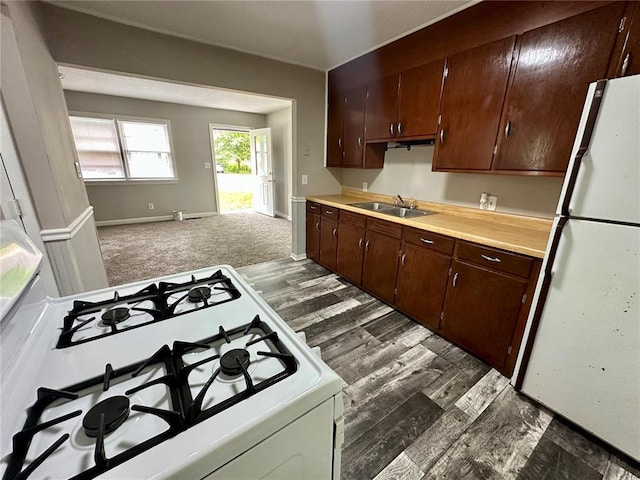 317 Marion Ave, Sikeston, MO 63801 - kitchen with white appliances, a sink, light countertops, dark wood-type flooring, and dark brown cabinets